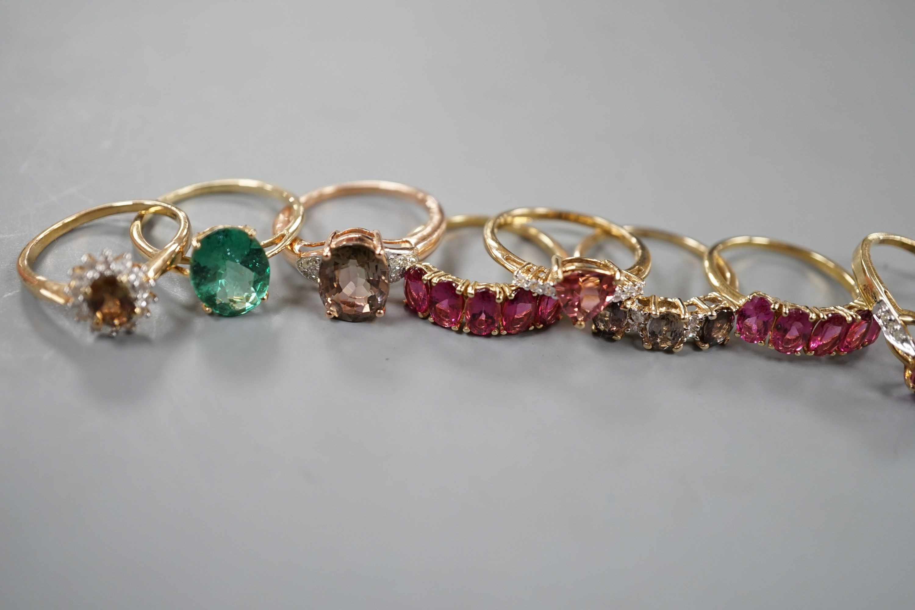 Seven assorted modern 9ct gold and gem set dress rings, including rubellite and a 14ct gold and garnet ring